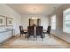 Formal dining room with a modern chandelier, large window, and elegant decor at 1856 Kingsmere Run Dr, Loganville, GA 30052