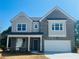 Charming two-story home with a two-car garage, brick facade, and a beautifully landscaped front yard at 1856 Kingsmere Run Dr, Loganville, GA 30052