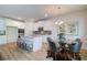 Eat-in kitchen featuring white cabinets, stainless steel appliances, and a modern glass top dining set at 1856 Kingsmere Run Dr, Loganville, GA 30052