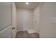 Functional laundry room with a door, tiled floor, and wire rack at 1856 Kingsmere Run Dr, Loganville, GA 30052