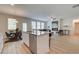 Open-concept living space with kitchen and dining, featuring stainless steel appliances and a fireplace at 1856 Kingsmere Run Dr, Loganville, GA 30052