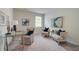 Cozy home office with a glass desk, comfortable chairs, and natural light at 1856 Kingsmere Run Dr, Loganville, GA 30052