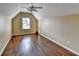 The bedroom features hardwood floors, a ceiling fan, and an abundance of natural light at 1921 Harvest Way, Loganville, GA 30052