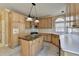 Well-lit kitchen with a kitchen island, granite countertops, stainless steel appliances, and a tile floor at 1921 Harvest Way, Loganville, GA 30052