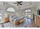 Spacious main bedroom with tray ceiling, hardwood floors, and French doors to the backyard at 1921 Harvest Way, Loganville, GA 30052