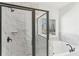 Modern bathroom with a glass-enclosed shower and a soaking tub near a window with nature views at 3278 Greenhill Dr, Villa Rica, GA 30180
