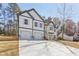 Modern two-story home with a two-car garage, attractive curb appeal, and a large concrete driveway at 3278 Greenhill Dr, Villa Rica, GA 30180