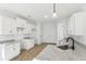 Bright kitchen with white cabinets, granite countertops, and stainless steel faucet at 3278 Greenhill Dr, Villa Rica, GA 30180