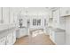Well-lit kitchen features an island, wood floor, granite countertops, and backyard views at 3278 Greenhill Dr, Villa Rica, GA 30180