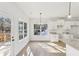 Open kitchen and eat-in area offers wood floors, white cabinets, access to outdoor patio at 3278 Greenhill Dr, Villa Rica, GA 30180