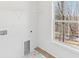 Bright laundry room with a window and white marble-like flooring at 3278 Greenhill Dr, Villa Rica, GA 30180