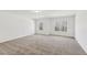 Spacious carpeted living room bathed in natural light from several windows at 3278 Greenhill Dr, Villa Rica, GA 30180