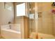 Stylish bathtub and shower combo featuring a glass door and tile surround at 5114 Arnold St, Covington, GA 30014