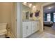 Bright bathroom with double sinks and a view into the bedroom at 5114 Arnold St, Covington, GA 30014