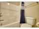Clean bathroom with shower-tub combo, and white tile, including neutral colored shower curtain for an updated look at 5114 Arnold St, Covington, GA 30014