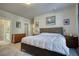 A well-lit bedroom showcases a comfortable bed and ensuite bathroom at 5114 Arnold St, Covington, GA 30014
