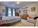 Comfortable bedroom featuring a bed, sitting area, dresser, and natural lighting at 5114 Arnold St, Covington, GA 30014