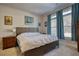 Cozy bedroom featuring a large bed, wood furniture, and natural light streaming through the windows at 5114 Arnold St, Covington, GA 30014