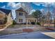 Charming two-story home featuring a covered front porch and mature landscaping at 5114 Arnold St, Covington, GA 30014