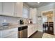 Bright kitchen features white cabinets, stainless steel appliances and granite countertops at 5114 Arnold St, Covington, GA 30014