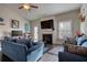 Comfortable living room with fireplace, large TV, and plush blue sofas at 5114 Arnold St, Covington, GA 30014