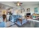 Open concept living room with modern furniture, blue sofa, and adjacent kitchen view at 5114 Arnold St, Covington, GA 30014