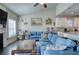 Open concept living room with modern furniture, blue sofa, and adjacent kitchen view at 5114 Arnold St, Covington, GA 30014
