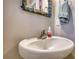 Close-up of the stylish powder room with decorative mirror and white pedestal sink at 5114 Arnold St, Covington, GA 30014