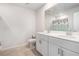 A clean bathroom featuring a double sink vanity, a toilet and a mirror at 849 Sara Meadow Rd, Loganville, GA 30052