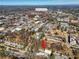 An aerial view shows the townhome in relation to the nearby wooded area and Downtown Roswell at 164 Oxbo Rd, Roswell, GA 30075