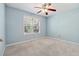 Bright bedroom with large window, ceiling fan, and neutral carpet; ready for personalization at 164 Oxbo Rd, Roswell, GA 30075