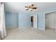 Carpeted bedroom with walk-in closets and ceiling fan at 164 Oxbo Rd, Roswell, GA 30075