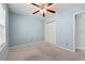Carpeted bedroom with ceiling fan, closet, and natural light from the window at 164 Oxbo Rd, Roswell, GA 30075