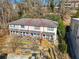Charming townhome with a inviting front porch, steps leading to a landscaped area, and a peaceful surrounding forest at 164 Oxbo Rd, Roswell, GA 30075