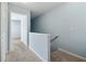 Upstairs hallway with carpet, railing, and view into an adjacent room at 164 Oxbo Rd, Roswell, GA 30075