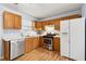Updated kitchen featuring wooden cabinets, white appliances, and bright, clean countertops at 164 Oxbo Rd, Roswell, GA 30075