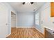 Spacious kitchen area with laminate flooring, featuring a view of a pantry and backyard access at 164 Oxbo Rd, Roswell, GA 30075