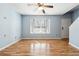 Sunlit living room featuring hardwood floors, a bay window, ceiling fan and neutral walls at 164 Oxbo Rd, Roswell, GA 30075
