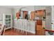 Open-concept kitchen with bar stool seating, wooden cabinets, and great lighting at 122 Little Ridge Rd, Berkeley Lake, GA 30096