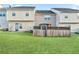 A backyard with green grass, a wooden fence, and a door that leads to the house at 129 Prospect Path, Hiram, GA 30141