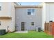 A backyard features a well-maintained lawn and a door to the home at 129 Prospect Path, Hiram, GA 30141