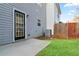 Backyard view with lawn, a small patio, a wooden privacy fence, and the side of the home at 129 Prospect Path, Hiram, GA 30141