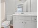 Bright bathroom featuring a white vanity, toilet, mirror, and neutral color scheme at 129 Prospect Path, Hiram, GA 30141