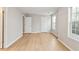 A spacious bedroom with laminate floors, light gray walls, and natural light from the window at 129 Prospect Path, Hiram, GA 30141