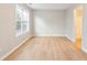 A bedroom with light gray walls, laminate floors, and an open door to a bathroom at 129 Prospect Path, Hiram, GA 30141