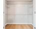 A walk-in closet featuring laminate floors, white walls, and multiple metal shelving units at 129 Prospect Path, Hiram, GA 30141