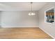 Open dining room with wood-look flooring and views into the kitchen at 129 Prospect Path, Hiram, GA 30141