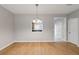 Bright dining room features wood-look flooring and view into the kitchen at 129 Prospect Path, Hiram, GA 30141