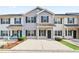 Charming two-story townhome with a well-maintained exterior, black shutters and a concrete driveway at 129 Prospect Path, Hiram, GA 30141