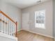 Inviting foyer with wood-look floors, white trim, a window for natural light, and a white front door at 129 Prospect Path, Hiram, GA 30141